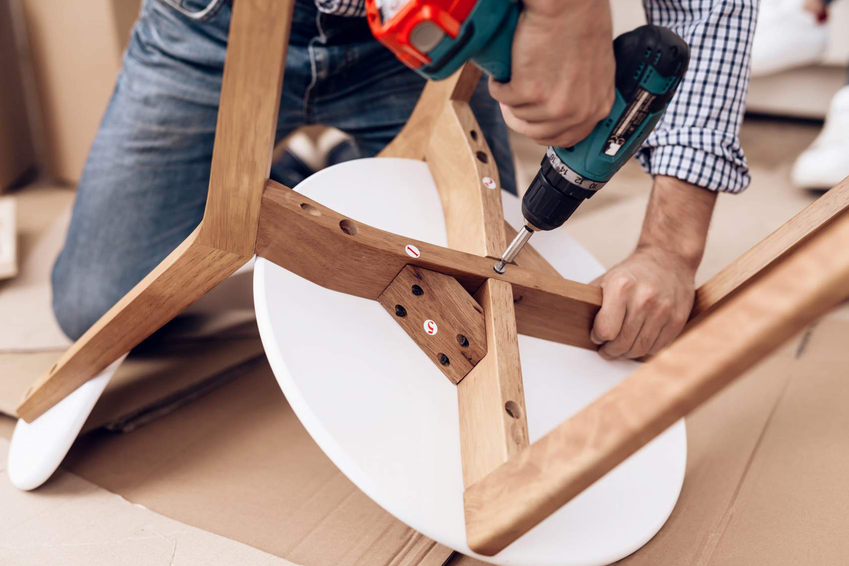 Assembling furniture with a power drill, a handyman furniture assembly service - Handyman Group SFL