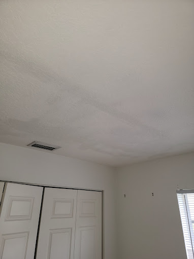 Freshly painted bedroom with smooth ceiling and white closet doors - Handyman Group SFL
